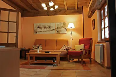 a living room with a couch and two chairs at Apartamentos El Llago in Boal