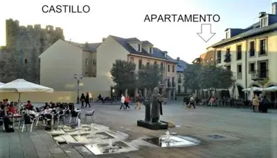 a group of people sitting around a statue in a courtyard at XOXO - Encina in Ponferrada