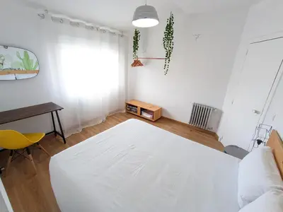 a living room with a white bed and a desk at XOXO - Encina in Ponferrada