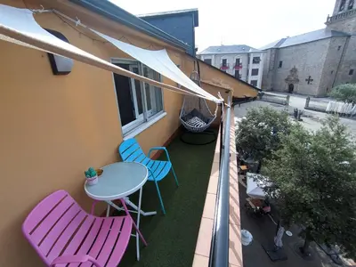 a balcony with two chairs and a table on it at XOXO - Encina in Ponferrada