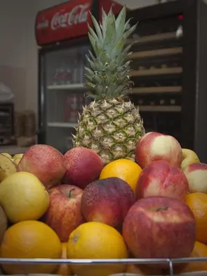a pile of fruit with a pineapple on top of it at Hotel Mar de Plata in Sarria