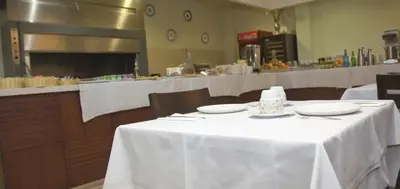 a table in a restaurant with a white table cloth at Hotel Mar de Plata in Sarria