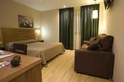 a hotel room with a bed and a couch at Hotel Mar de Plata in Sarria