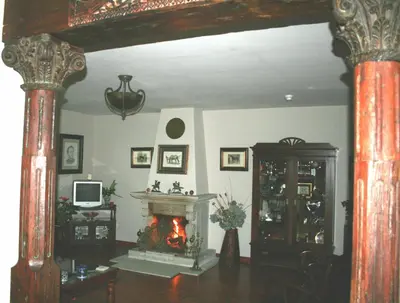 a living room with a fire in a fireplace at Hotel Rural Yeguada Albeitar in Villayón