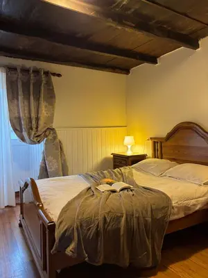 a bedroom with a large bed and a window at Casa Tipica De La Zona con barbacoa y parking in Muras