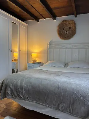 a bedroom with a large bed with a teddy bear on the wall at Casa Tipica De La Zona con barbacoa y parking in Muras