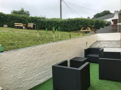 a retaining wall with black chairs and a picnic table at Casa Tipica De La Zona con barbacoa y parking in Muras