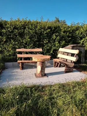 two wooden benches and a picnic table in a park at Casa Tipica De La Zona con barbacoa y parking in Muras