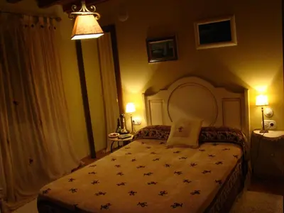 a bedroom with a large bed in a room at A Casa de Mañas in Mondoñedo