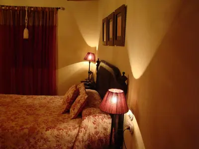 a bedroom with a bed with two lamps on it at A Casa de Mañas in Mondoñedo