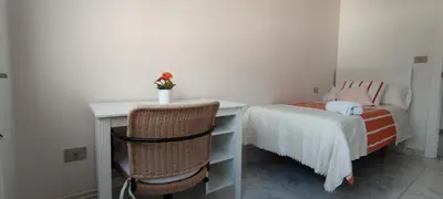 a bedroom with a desk and a bed and a chair at Xabarin Apartment in Abadín