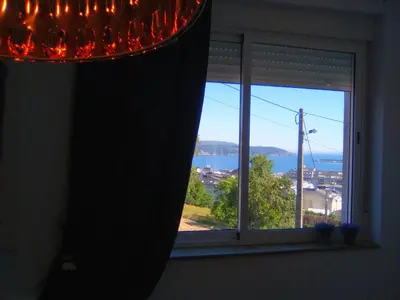 a room with a window with a view of the water at Apartamento en Viveiro in Viveiro