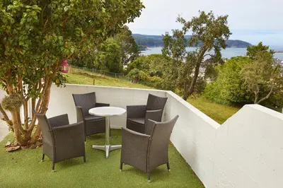 a table and chairs on a balcony with a view at Apartamento en Viveiro in Viveiro