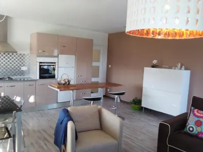 a kitchen with a couch and a table in a room at Apartamento en Viveiro in Viveiro