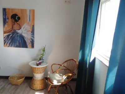 a room with a chair and a painting on the wall at Apartamento en Viveiro in Viveiro