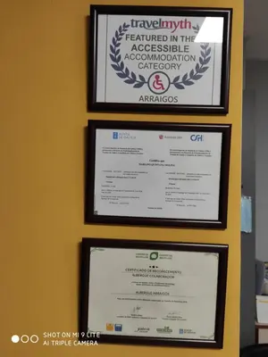 four framed certificates are hanging on a wall at Arraigos in Melide