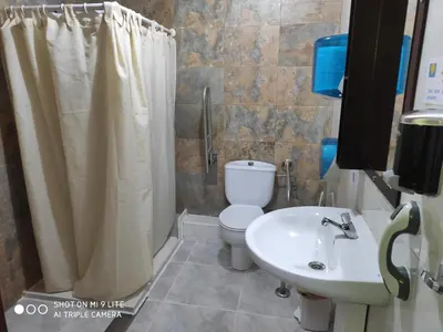 a bathroom with a toilet and a sink and a shower at Arraigos in Melide