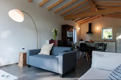 a living room with a blue couch and a table at Casa das Landras in Chantada