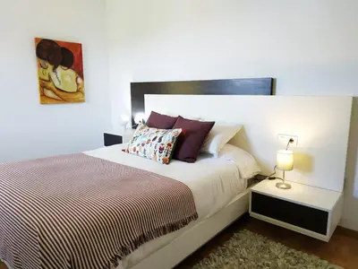 a bedroom with a large bed with a pillow at Piso con excelentes vistas in Viveiro