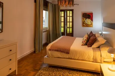 a bedroom with a bed with a dresser and a window at Piso con excelentes vistas in Viveiro