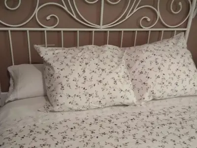 a bed with a bunch of pillows on it at Piso con excelentes vistas in Viveiro