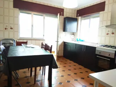 a kitchen with a table and some chairs in a room at Piso con excelentes vistas in Viveiro