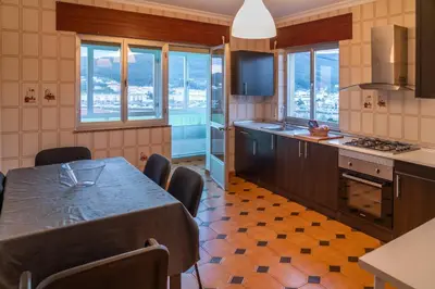 a kitchen with a table and some chairs in it at Piso con excelentes vistas in Viveiro
