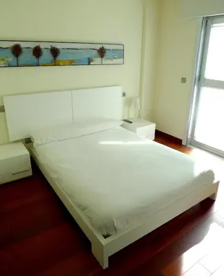 a large white bed in a room with a window at PR Blanco in Santiago de Compostela