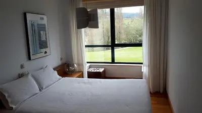 a bedroom with a bed and a large window at PR Blanco in Santiago de Compostela
