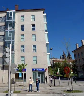 two people standing in front of a tall building at PR Blanco in Santiago de Compostela
