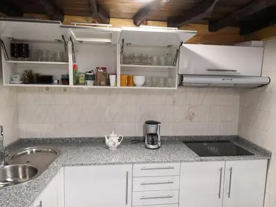 a kitchen with a sink and a counter top at Casa Carlán in Melide