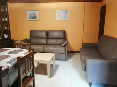 a living room with a couch and a table at Casa Carlán in Melide