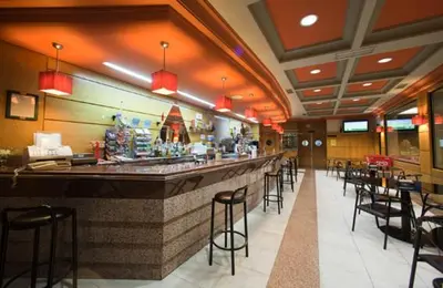 a bar in a restaurant with a lot of chairs at Hostal Restaurante Terra Chá in Villalba