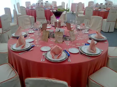 a table with a red table cloth and plates and napkins at Hostal Restaurante Terra Chá in Villalba