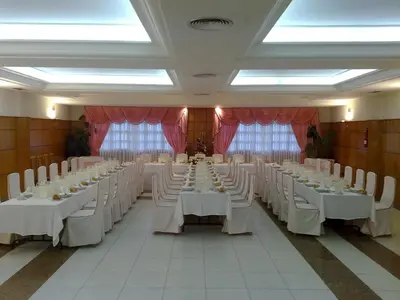 a large banquet hall with white tables and white chairs at Hostal Restaurante Terra Chá in Villalba