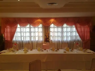 a large table with chairs and a large window at Hostal Restaurante Terra Chá in Villalba
