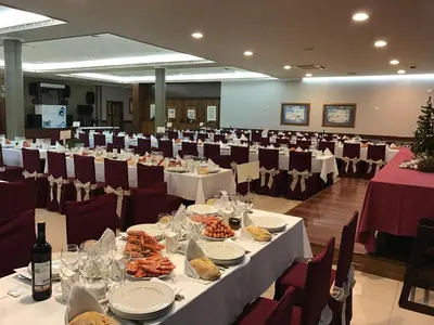a banquet hall with white tables and red chairs at Hostal-Restaurante Paris in Forcarei