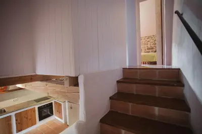 a staircase in a house with white walls and wooden floors at O Curralino in Vilacoba