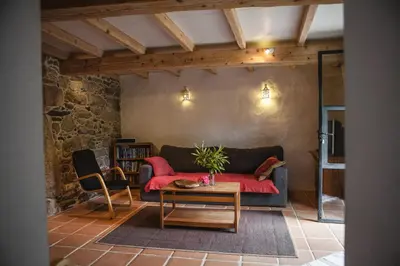 a living room with a couch and a table at O Curralino in Vilacoba