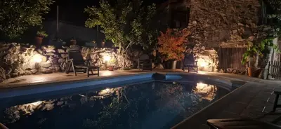 a swimming pool with chairs and lights in a yard at casa cristimil -san amaro in Salamonde