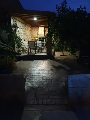 a patio at night with a table and chairs at casa cristimil -san amaro in Salamonde