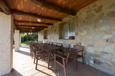a dining room with a wooden table and chairs at Casa de Sabela in Culleredo