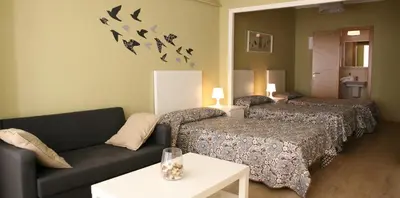 a living room with two beds and a couch at Casa Matías in Sarria