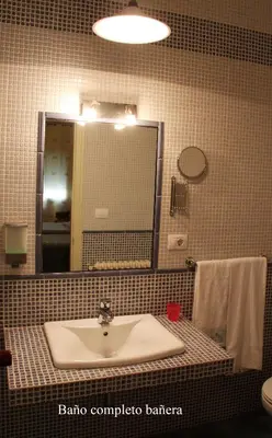 a bathroom with a sink and a mirror at Casa Matías in Sarria