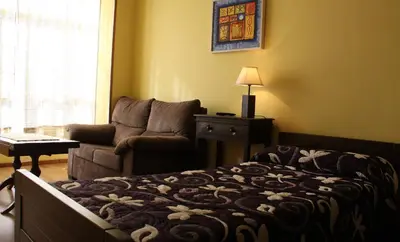 a living room with a bed and a couch at Casa Matías in Sarria