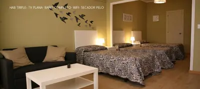 a living room with two couches and a couch at Casa Matías in Sarria