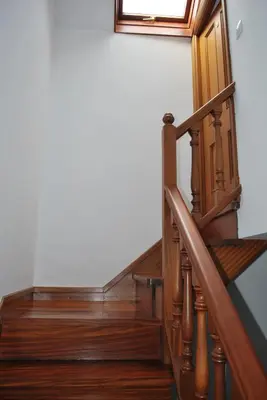 a stairway with wooden stairs and a window at Pensión Acibeche in Santiago de Compostela