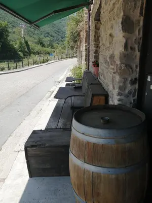 a large wooden barrel sitting next to a building at El Puente Peregrino in Trabadelo