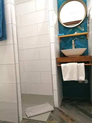 a bathroom with a sink and a mirror at El Puente Peregrino in Trabadelo
