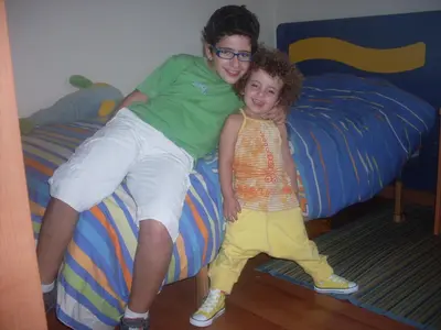 a man and a little girl sitting on a bed at Lar Cuche in Ourense